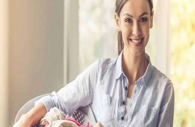 beautiful-young-woman-holding-basin-with-laundry-min